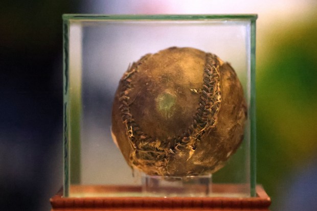 A baseball from the infamous 1919 World Series, known for the Black Sox scandal, which was discovered in Tribune Tower as the building was being redeveloped, is seen at Harry Caray's Tavern on Tuesday, March 18, 2025. (Terrence Antonio James/Chicago Tribune)