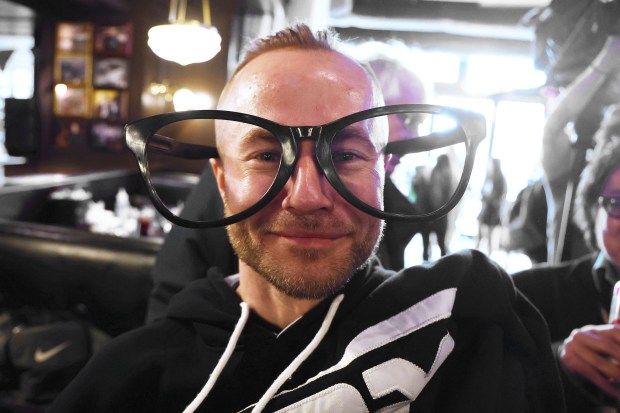 Patrick Dunaj wears an oversized pair of Harry Caray-style glasses at Harry Caray's Tavern on Tuesday, March 18, 2025, during the 27th annual toast to the late broadcaster. (Terrence Antonio James/Chicago Tribune)