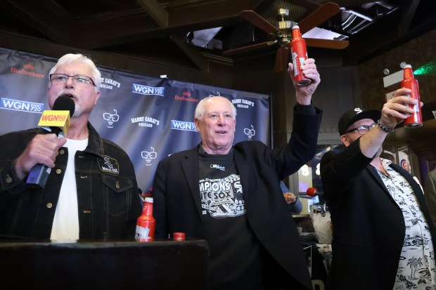 Former Illinois Gov. Pat Quinn, center, hoists a beer with fans during the 27th annual toast to the late broadcaster Harry Caray and a ceremony to break a purported White Sox "curse" at Harry Caray's Tavern on Tuesday, March 18, 2025. (Terrence Antonio James/Chicago Tribune)