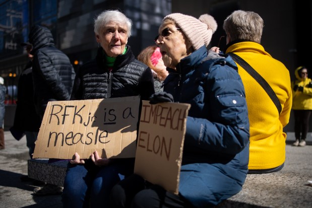 Sister-in-laws, Susan Fenske, of Forest Park, and Pat Leshuk, of Chicago, participate in a rally at Daley Plaza before marching to Trump Tower for International Women's Day. (Audrey Richardson/Chicago Tribune)