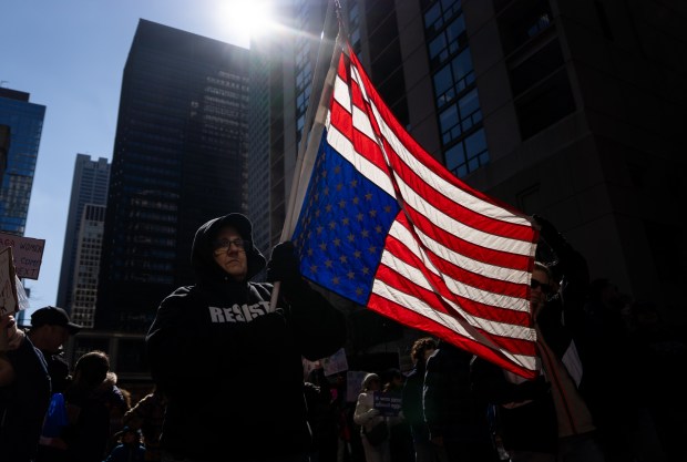 People gather at Daley Plaza and march to Trump Tower for International Women's Day on March 8, 2025. (Audrey Richardson/Chicago Tribune)