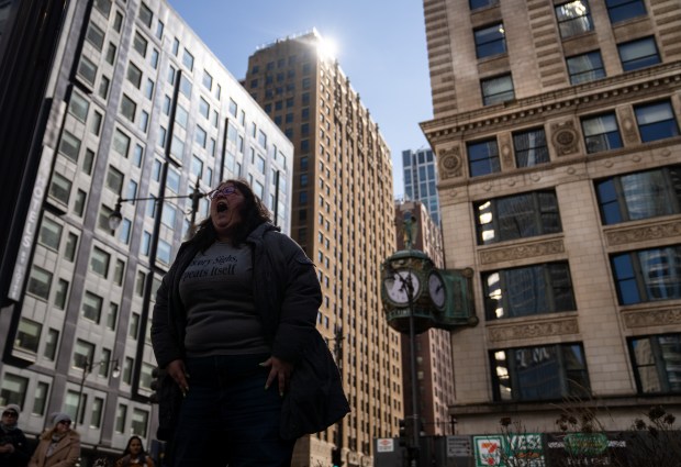 Lauren Cali screams at the top of her lungs while marching to Trump Tower for International Women's Day in Chicago on March 8, 2025. "I just feel like we need it," Cali said. (Audrey Richardson/Chicago Tribune)