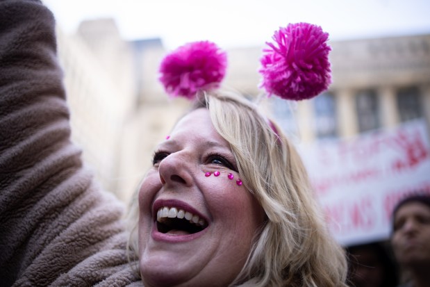 Crissy Calandra, of Schaumburg, participates in a rally as people gather at Daley Plaza before marching to Trump Tower for International Women's Day. "I'm a teacher and I'm here for them," Calandra said. "And my boyfriend's daughters. It's important to me that their voices matter." (Audrey Richardson/Chicago Tribune)