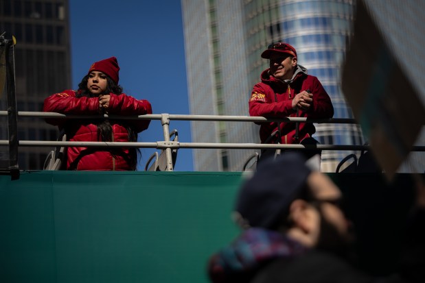 Onlookers watch from a tour bus as thousands march to Trump Tower for International Women's Day. (Audrey Richardson/Chicago Tribune)