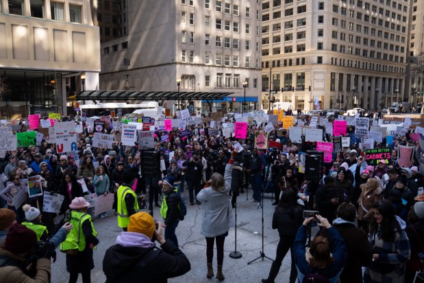 40th Ward Committee person Maggie O'Keefe, center, speaks to thousands at Daley Plaza before marching to Trump Tower for International Women's Day on March 8, 2025. (Audrey Richardson/Chicago Tribune)