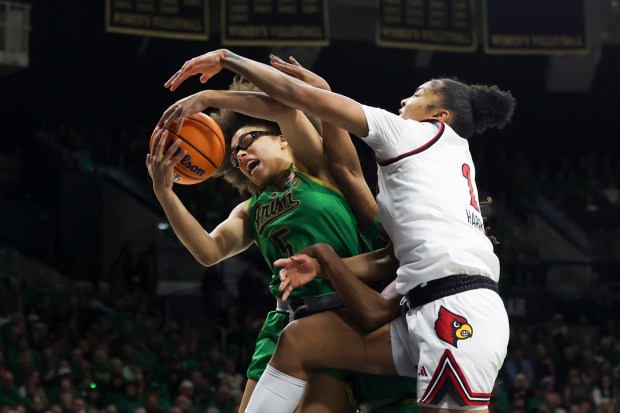 Notre Dame Fighting Irish guard Olivia Miles (5) battles Louisville Cardinals forward Nyla Harris (2) for a rebound during the first quarter at Purcell Pavilion in South Bend on Sunday, March 2, 2025. (Eileen T. Meslar/Chicago Tribune)