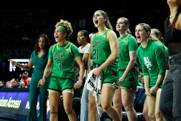 Notre Dame Fighting Irish players celebrate after the Louisville Cardinals were called for a charge during the first quarter at Purcell Pavilion in South Bend on Sunday, March 2, 2025. (Eileen T. Meslar/Chicago Tribune)