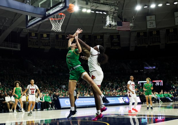 Notre Dame Fighting Irish guard Sonia Citron (11) goes up for a shot while guarded by Louisville Cardinals forward Olivia Cochran (44) during the third quarter at Purcell Pavilion in South Bend on Sunday, March 2, 2025. (Eileen T. Meslar/Chicago Tribune)