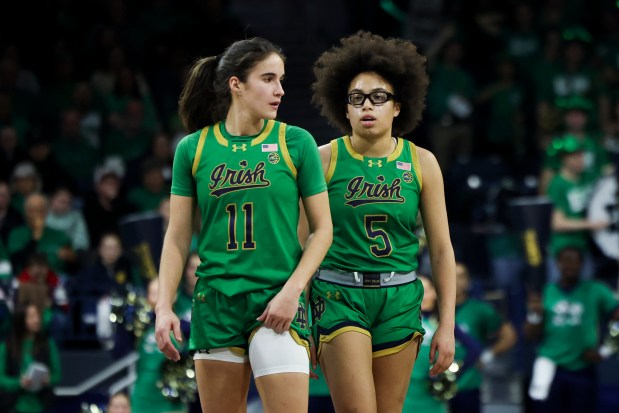 Notre Dame Fighting Irish guard Sonia Citron (11) and Notre Dame Fighting Irish guard Olivia Miles (5) speak to each other during a stoppage in the fourth quarter at Purcell Pavilion in South Bend on Sunday, March 2, 2025. (Eileen T. Meslar/Chicago Tribune)