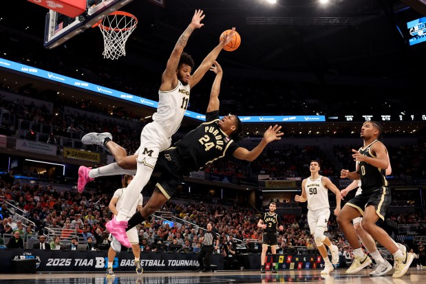 Gicarri Harris #24 of the Purdue Boilermakers goes up for a layup against Roddy Gayle Jr. #11 of the Michigan Wolverines during the first half in the Big Ten men's basketball tournament quarterfinals at Gainbridge Fieldhouse on March 14, 2025 in Indianapolis, Indiana. (Photo by Michael Reaves/Getty Images)