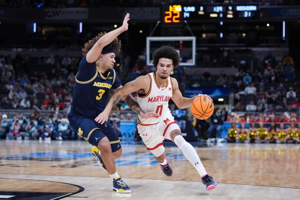 Maryland guard Ja'Kobi Gillespie (0) drives on Michigan Wolverines guard Tre Donaldson (3) during the first half of an NCAA college basketball game in the semifinals of the Big Ten Conference tournament in Indianapolis, Saturday, March 15, 2025. (AP Photo/Michael Conroy)