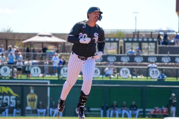 Chicago White Sox third base Miguel Vargas (20) trots around the bases after hitting a home run in the second inning of a spring training baseball game against the Los Angeles Dodgers, Saturday, March 8, 2025, in Phoenix. (AP Photo/Darryl Webb)