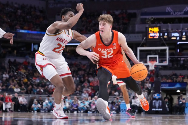 Illinois guard Kasparas Jakučionis (32) drives past Maryland forward Jordan Geronimo during a Big Ten Tournament quarterfinal on March 14, 2025, in Indianapolis. (Michael Conroy/AP)