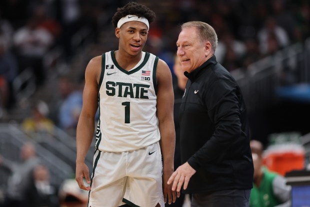 Michigan State's Jeremy Fears Jr. talks with coach Tom Izzo during a game against against Oregon in a Big Ten Tournament quarterfinal at Gainbridge Fieldhouse on March 14, 2025, in Indianapolis. (Michael Reaves/Getty Images)