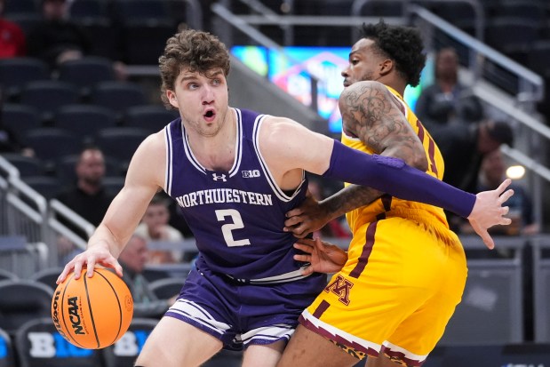 Northwestern forward Nick Martinelli (2) drives against Minnesota guard Femi Odukale during the first half of a Big Ten Tournament game on March 12, 2025, in Indianapolis. (Michael Conroy/AP)