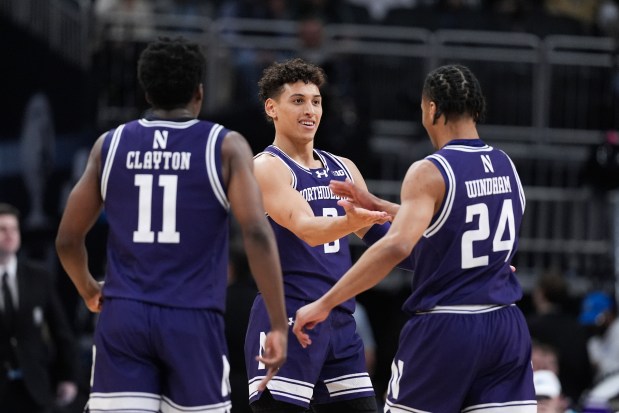 Northwestern guard Jordan Clayton (11), Ty Berry, middle, and K.J. Windham celebrate during the second half of a Big Ten Tournament game against Minnesota on March 12, 2025, in Indianapolis. (Michael Conroy/AP)