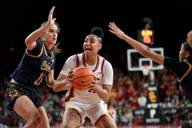 Southern California guard JuJu Watkins goes to the basket against Notre Dame guards Sonia Citron, left, and Hannah Hidalgo during the second half of an NCAA college basketball game, Saturday, Nov. 23, 2024 in Los Angeles. (AP Photo/Eric Thayer)