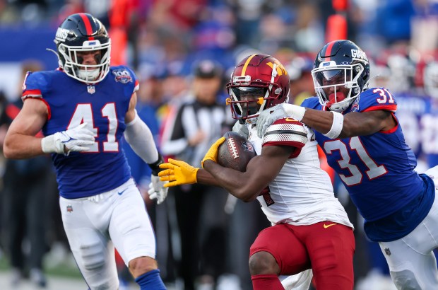 Commanders receiver Olamide Zaccheaus (14) fights for yards against the Giants' Tyler Nubin (31) on Nov. 3, 2024, in East Rutherford, N.J. (Al Bello/Getty Images)