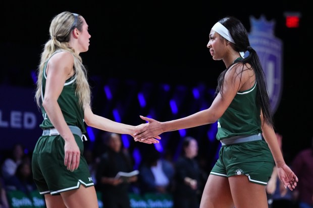 Rose's Angel Reese, right, slaps hands with teammate Lexie Hull after scoring against the Lunar Owls on Feb. 21, 2025, in Medley, Fla. (Rich Storry/Getty Images)