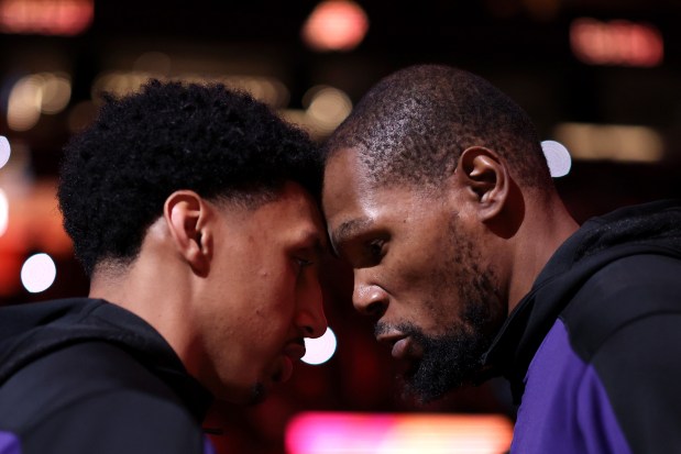 The Suns' Ryan Dunn, left, and Kevin Durant share a moment after being introduced before a game against the Pelicans on Feb. 28, 2025, in Phoenix. (Chris Coduto/Getty Images)