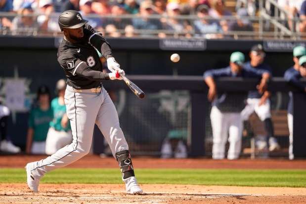 Chicago White Sox's Luis Robert Jr. hits a two-run home run against the Seattle Mariners during the third inning of a spring training baseball game Saturday, March 1, 2025, in Peoria, Ariz. (AP Photo/Lindsey Wasson)