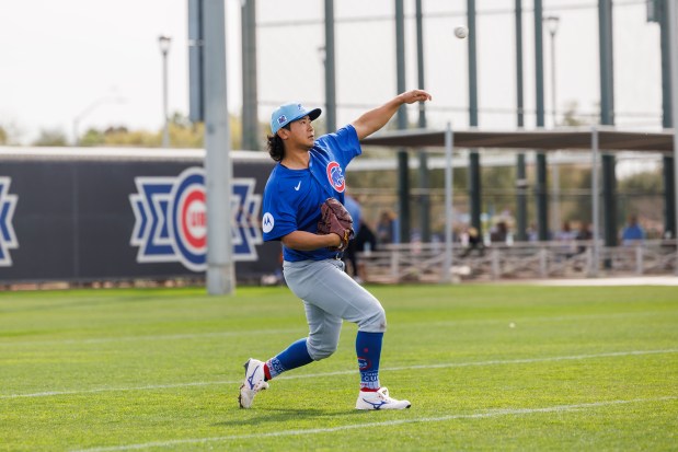 Cubs pitcher Shota Imanaga warms up before throwing batting practice during spring training at Sloan Park on Feb. 16, 2025, in Mesa, Ariz. (Armando L. Sanchez/Chicago Tribune)