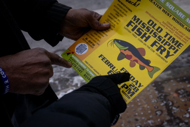 Gale Alston, Blacks in Green's chief of staff hands out a flyer for a Blacks in Green event. (Audrey Richardson/Chicago Tribune)