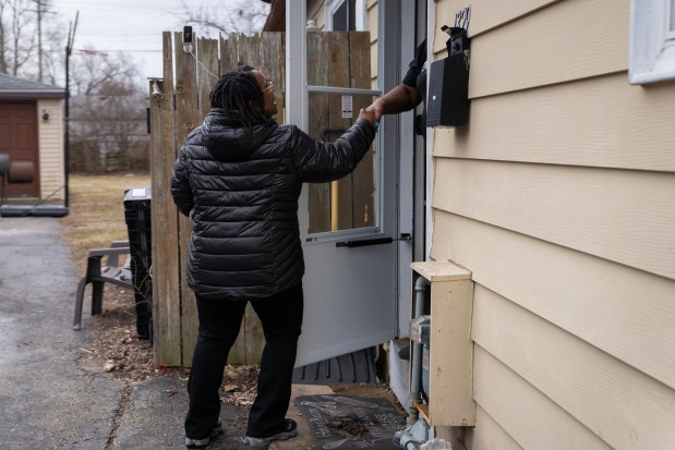 Sabrina Agee, of the Waukegan Housing Authority, says goodbye to a voucher holder, after performing an annual inspection on the home in Waukegan on March 4, 2025. (Audrey Richardson/Chicago Tribune)