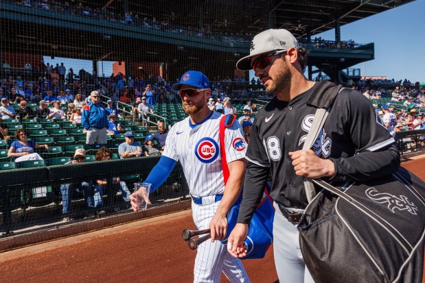 Chicago Cubs first base Michael Busch (29) talks with Chicago White Sox outfielder Mike Tauchman (18) before the Cubs play the White Sox at spring training at Sloan Park Saturday Feb. 22, 2025, in Mesa, Arizona. (Armando L. Sanchez/Chicago Tribune)