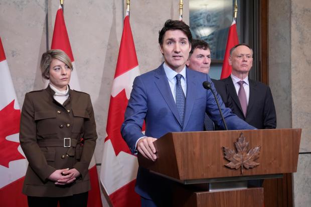 Prime Minister Justin Trudeau holds a news conference on imposed U.S. tariffs as Foreign Affairs Minister Melanie Joly, Finance Minister Dominic LeBlanc and Public Safety Minister David McGuinty look on in Ottawa on Tuesday, March 4, 2025.(Adrian Wyld /The Canadian Press via AP)