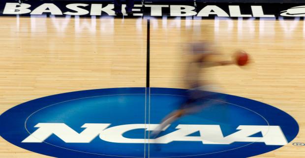 In this March 14, 2012, file photo, a player runs across the logo during NCAA college basketball practice in Pittsburgh. (AP Photo/Keith Srakocic)