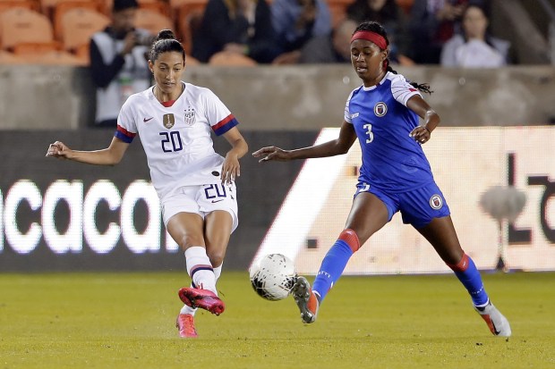 U.S. forward Christen Press passes the ball in front of Haiti defender Chelsea Surprise during an Olympic qualifying match Jan. 28, 2020, in Houston. (Michael Wyke/AP)