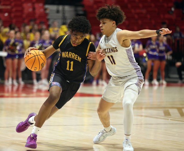 Warren's Braylon Walker drives against Rolling Meadows' Jaeden Warrener