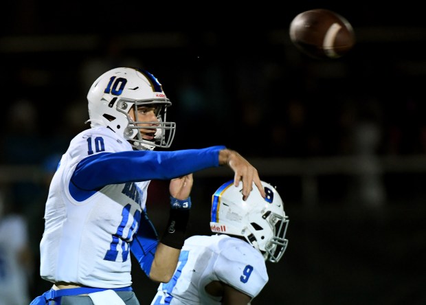 Warren quarterback Jack Wolf throws a pass 