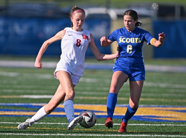 Mundelein's Carlie Bestler tries to move the ball past Lake Forest's Hanna Sands