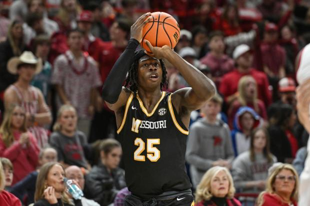 Missouri guard Mark Mitchell shoots a three-point shot against Arkansas during the first half on Feb. 22, 2025, in Fayetteville, Ark. (AP Photo/Michael Woods)