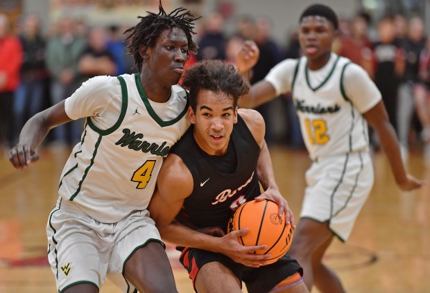 Benet's Blake Fagbemi drives against Waubonsie Valley's Moses Wilson