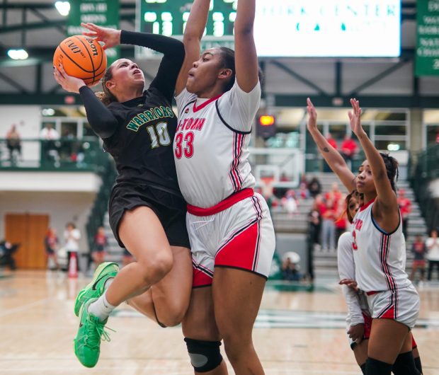 Waubonsie Valley's Danyella Mporokoso puts up a shot against Alton's Talia Norman