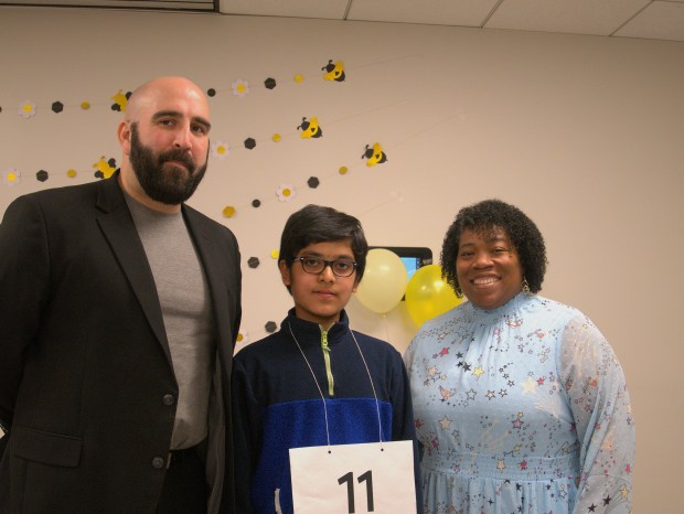 Michael Karner, regional superintendent of schools, and Courtney Curry, assistant regional superintendent, pose with Regional Spelling Bee winner Visharad Sathish. The 12-year-old won after over 40 rounds. (Joe States/Lake County News-Sun) 