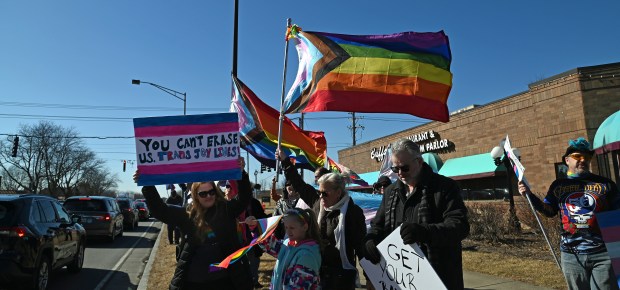 Center, Sophia Kuzel, 8, a third-grader from Des Plaines, whose pronouns are she/her and identifies as transgender, is supported by family, including on left parent Arlene Kuzel at the Rally for Love, Protest for Love event in Buffalo Grove on Saturday, March 8, 2025. (Karie Angell Luc/Pioneer Press)