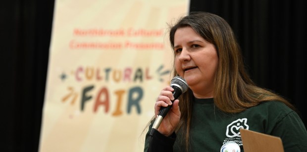 Jennifer Saperstein of Northbrook, Community Commission chair, welcomes the audience to the Cultural Fair on Feb. 23, 2025 at the North Suburban NSYMCA (2705 Techny Road). (Karie Angell Luc/Pioneer Press)