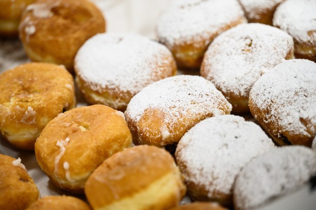 Rows of paczki sit on display for visitors at Carpathia Deli in Schererville as vistors stock up on the pastry for Paczki Day on Tuesday, March 4, 2025. (Kyle Telechan/for the Post-Tribune)