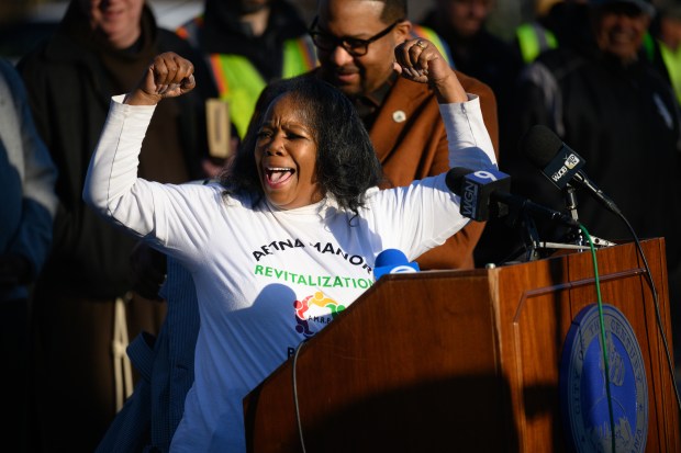 Aetna Manor Revitalization Program founder Penelope Love shows off her shirt as she speaks during a celebration of a new wave of demolitions in the neighborhood on Monday, March 10, 2025. (Kyle Telechan/for the Post-Tribune)