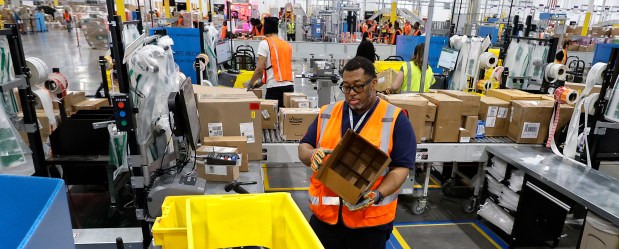 Amazon employee Ron Edwards works at a prep station during a ribbon-cutting ceremony and tour of the Amazon Fulfillment Center in Merrillville. The event showcased Amazon's latest Indiana investment, featuring advanced technology that processes hundreds of thousands of packages daily. The presentation took place on Wednesday, March 19, 2025. (John Smierciak / for the Post Tribune)