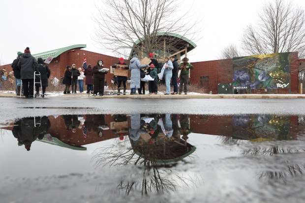 Demonstrators begin gathering for a rally to protest ongoing National Park Service cuts outside the Indiana Dunes Visitor Center Saturday, March 1, 2025, in Porter, Indiana. (John J. Kim/Chicago Tribune)