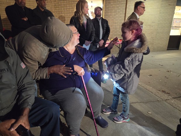 Lili Parker Owens (center) reaches out to Rylee Clark (right) during a vigil for Parker Owens's daughter, Briana Payne, and granddaughters Aurorah, Ava and Alayna Payne at Bailey Elementary School in Lake Station on Feb. 28. Rylee was one of Aurorah's best friends. (Michelle L. Quinn/Post-Tribune)