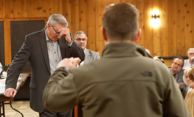 Tri-Creek Superintendent Andy Anderson, a St. John resident, asks Indiana State Rep. Hal Slager (left), R-Schererville, and State Sen. Dan Dernulc (center), R-Highland, a question during a town hall meeting to share updates on the 2025 Indiana legislative session and discuss community concerns at the St. John Township Community Center in Schererville on Saturday, March 15, 2025. (John Smierciak / for the Post-Tribune)