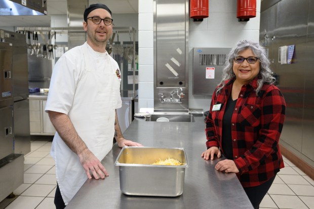 River Forest High School food service director Nick Alessandri, on left, poses for a photo with NWI Food Council Farm to School coordinator Veronica Jalomo in the school's kitchen on Friday, March 21, 2025. (Kyle Telechan/for the Post-Tribune)