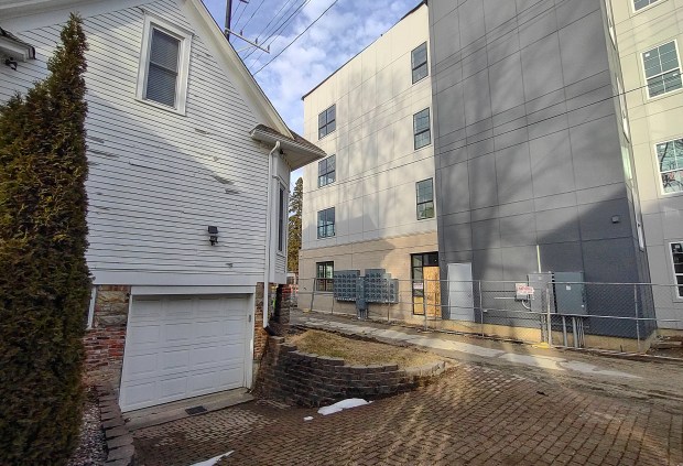 During Aug., 2024, the garage and basement of Ivy Boutique, left, and other area buildings in downtown Valparaiso were flooded with raw sewage in the vicinity of the new Linc development. Building owners blame the construction site for mismanagement of the stormwater and sewers. (Michael Gard/for the Post-Tribune)