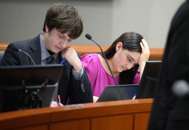 Chesterton debate team members Isabel Durkin, on right, and teammate Patrick Hansen take notes as opponent, Valparaiso senior Jorge Ramirez, speaks during a Valparaiso Chain of Lakes Watershed Group-sponsored debate on Monday, March 17, 2025. (Kyle Telechan/for the Post-Tribune)